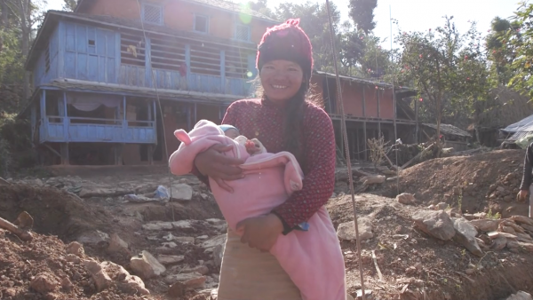 Nepalese woman smiles with her baby